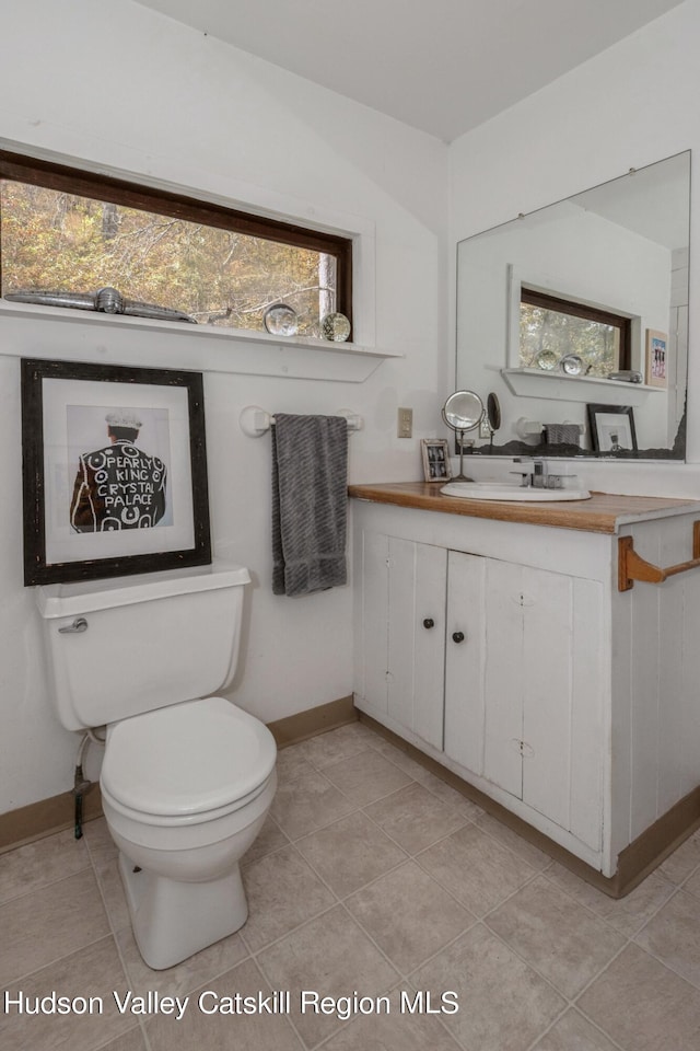 bathroom featuring tile patterned floors, vanity, and toilet