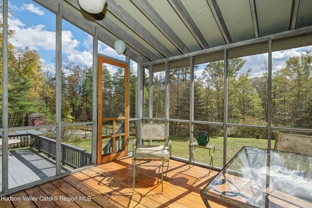 unfurnished sunroom with lofted ceiling