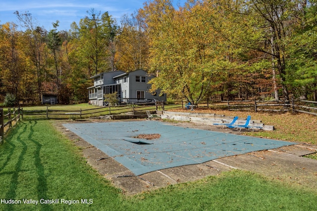 view of pool with a lawn and a patio