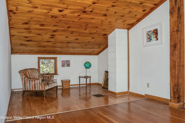 living area featuring hardwood / wood-style flooring, wood ceiling, and vaulted ceiling