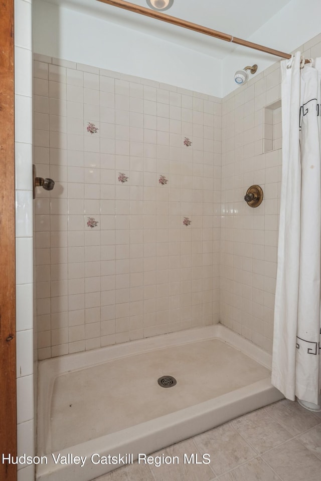 bathroom featuring tile patterned flooring and a shower with shower curtain