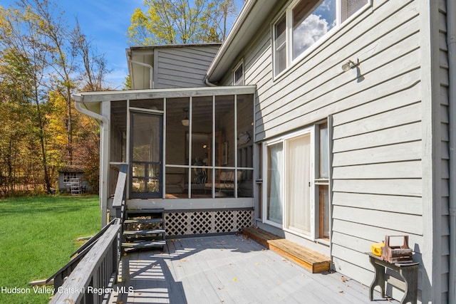 wooden terrace with a sunroom and a yard