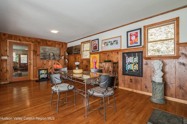 dining room featuring wooden walls and dark hardwood / wood-style flooring