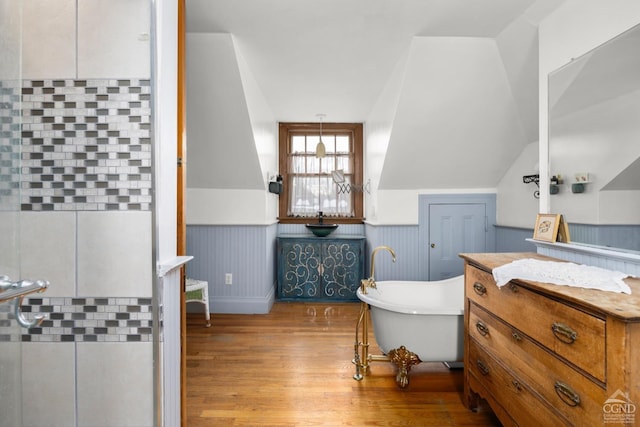 3630 Main St, Stone Ridge, NY 12484 - bathroom with wood finished floors, a soaking tub, a wainscoted wall, vanity, and lofted ceiling