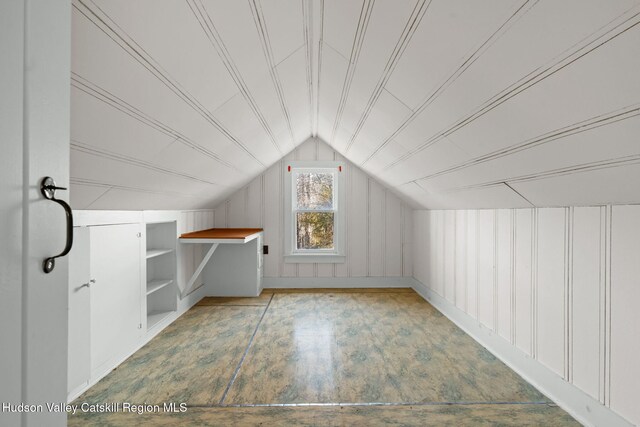 additional living space featuring lofted ceiling