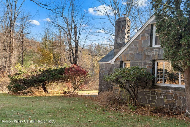 view of property exterior featuring a lawn