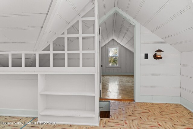 interior space featuring lofted ceiling and parquet flooring