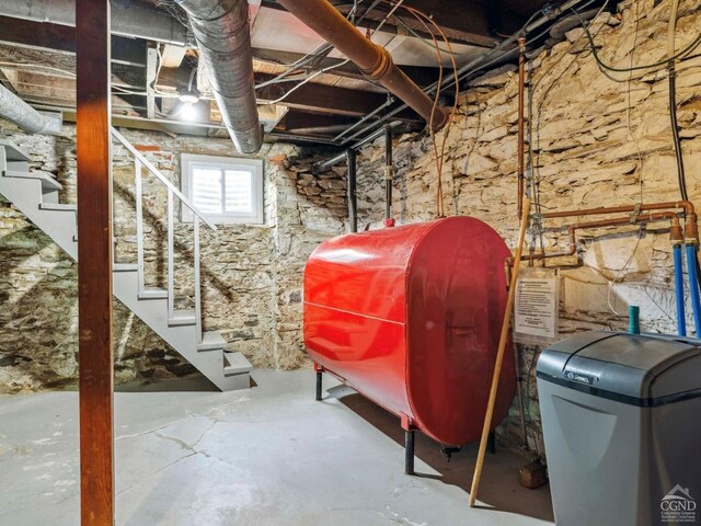 below grade area with oil tank, stairway, and a water softener system