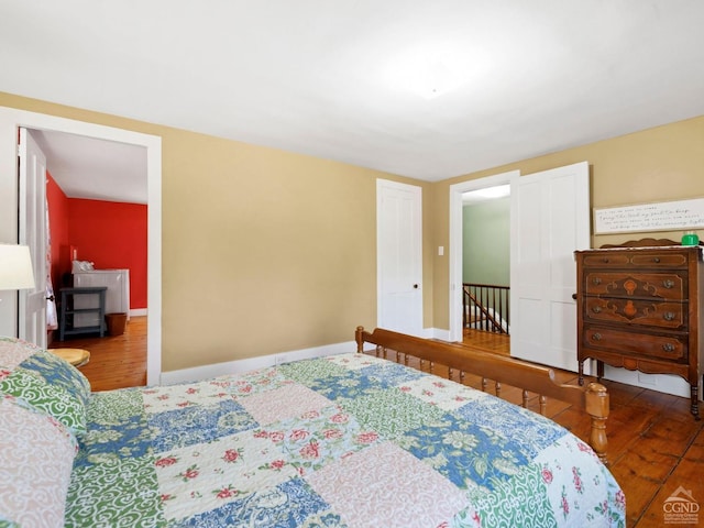 bedroom featuring wood finished floors and baseboards