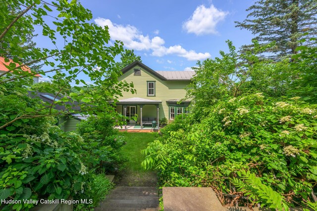 28 Riverview St, Stuyvesant, NY 12173 - view of property exterior featuring a sunroom, a metal roof, and a patio