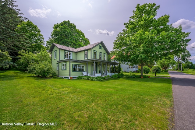 28 Riverview St, Stuyvesant, NY 12173 - view of side of property with covered porch, a yard, and a metal roof
