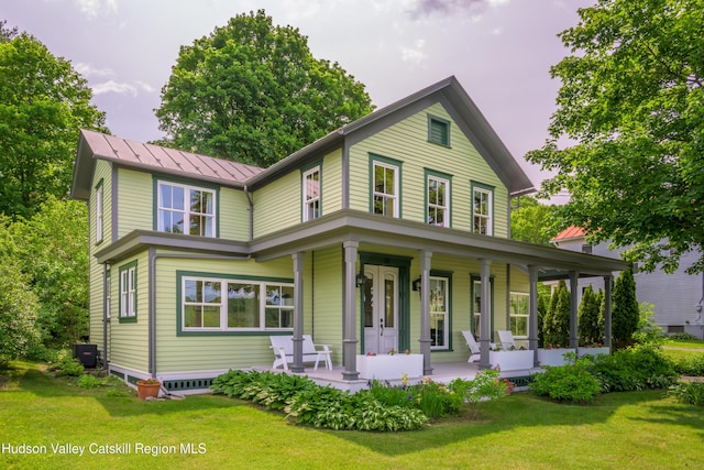 28 Riverview St, Stuyvesant, NY 12173 - view of front of home featuring a porch, a standing seam roof, a front yard, and a metal roof