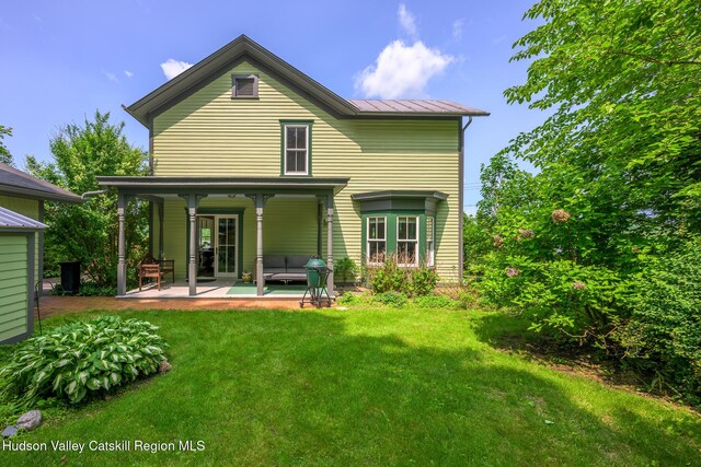 28 Riverview St, Stuyvesant, NY 12173 - rear view of property with a standing seam roof, a yard, a metal roof, a patio area, and outdoor lounge area