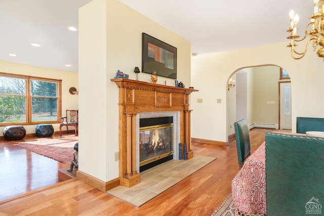 237 Christian Hill Rd, Cooperstown, NY 13326 - living room featuring arched walkways, a high end fireplace, light wood-style flooring, a chandelier, and recessed lighting