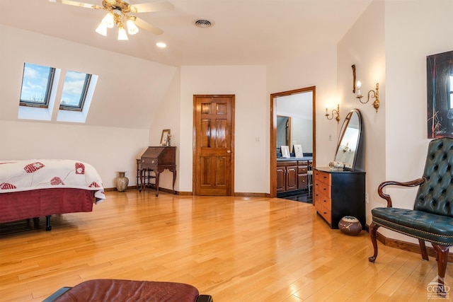 237 Christian Hill Rd, Cooperstown, NY 13326 - bedroom featuring light wood-style floors, a skylight, baseboards, and connected bathroom