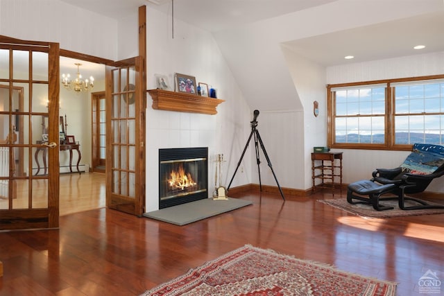 237 Christian Hill Rd, Cooperstown, NY 13326 - living area featuring wood finished floors, french doors, a tiled fireplace, baseboard heating, and a chandelier