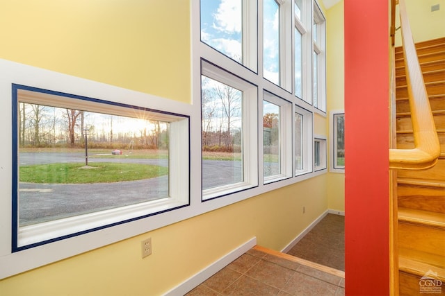 237 Christian Hill Rd, Cooperstown, NY 13326 - stairs with healthy amount of natural light, baseboards, tile patterned flooring, and a towering ceiling
