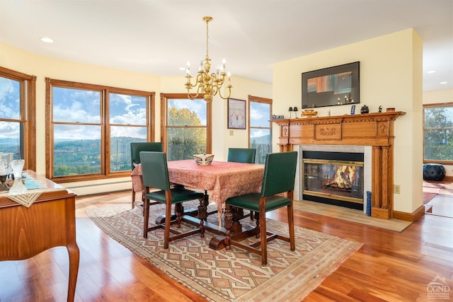 237 Christian Hill Rd, Cooperstown, NY 13326 - dining area featuring a baseboard heating unit, a chandelier, light wood-type flooring, a fireplace with flush hearth, and recessed lighting