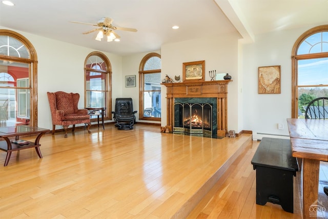 237 Christian Hill Rd, Cooperstown, NY 13326 - living room with a baseboard radiator, a fireplace, a ceiling fan, light wood finished floors, and recessed lighting