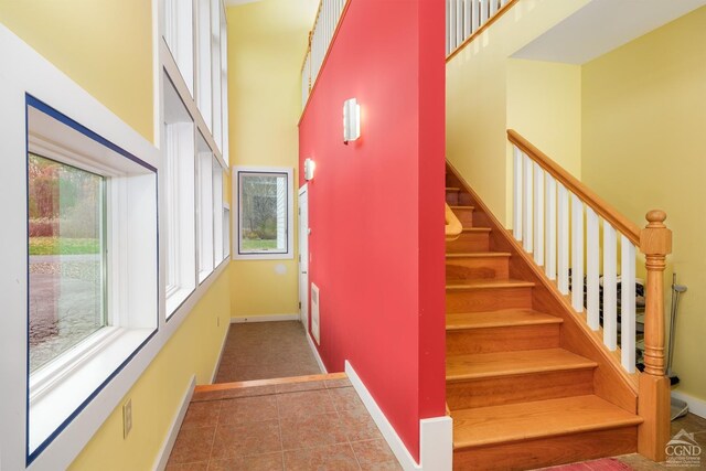 237 Christian Hill Rd, Cooperstown, NY 13326 - stairway with a towering ceiling, tile patterned flooring, and baseboards