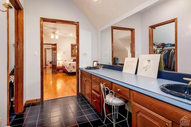 237 Christian Hill Rd, Cooperstown, NY 13326 - bathroom with double vanity, vaulted ceiling, ensuite bathroom, tile patterned floors, and ceiling fan