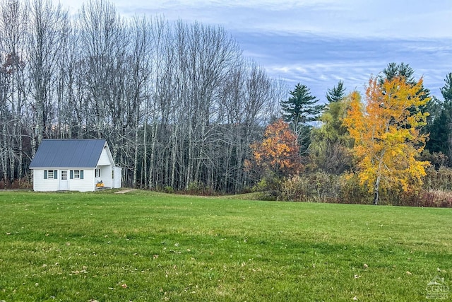237 Christian Hill Rd, Cooperstown, NY 13326 - view of grassy yard with an outdoor structure and a forest view