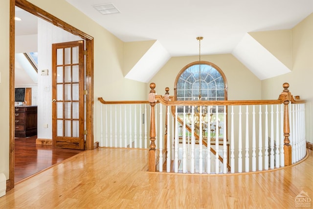 237 Christian Hill Rd, Cooperstown, NY 13326 - hall featuring wood finished floors, lofted ceiling, an upstairs landing, and a chandelier