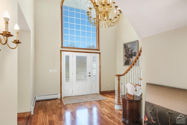 237 Christian Hill Rd, Cooperstown, NY 13326 - foyer with a chandelier, wood finished floors, baseboard heating, a towering ceiling, and stairway