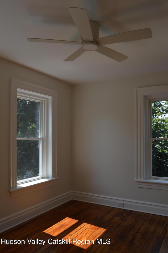 unfurnished room featuring dark hardwood / wood-style flooring and ceiling fan