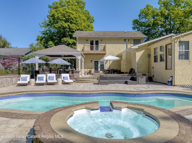 view of pool featuring fence, a patio, an outdoor living space, and an in ground hot tub