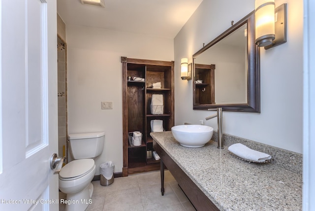 full bathroom featuring baseboards, a sink, toilet, and tile patterned floors