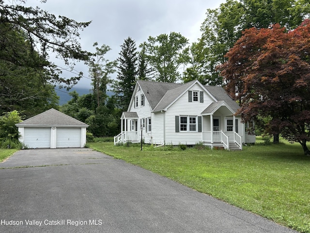 969 Blue Mountain Rd, Saugerties, NY 12477 - view of front of home with an outbuilding, a detached garage, a shingled roof, a front yard, and a porch