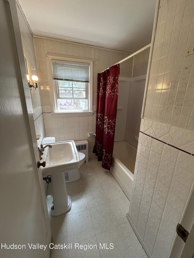 969 Blue Mountain Rd, Saugerties, NY 12477 - bathroom featuring tile walls, shower / bathtub combination with curtain, and radiator heating unit