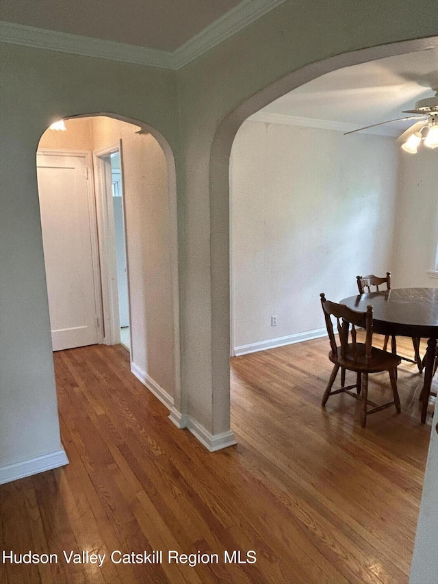 969 Blue Mountain Rd, Saugerties, NY 12477 - dining room featuring arched walkways, ornamental molding, wood finished floors, and ceiling fan