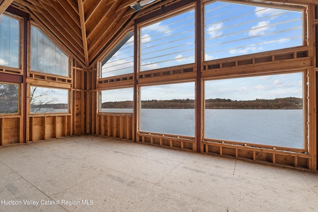 unfurnished sunroom featuring plenty of natural light, a water view, and vaulted ceiling