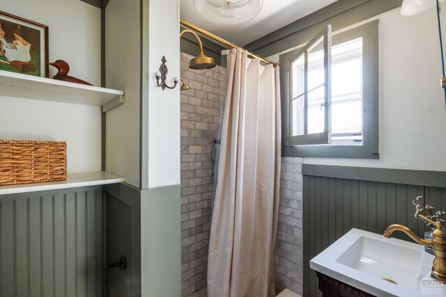 550-552 Columbia St, Hudson, NY 12534 - bathroom with a wainscoted wall, a tile shower, and a sink