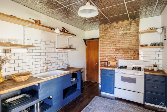 550-552 Columbia St, Hudson, NY 12534 - kitchen with open shelves, white gas range, blue cabinetry, butcher block counters, and an ornate ceiling