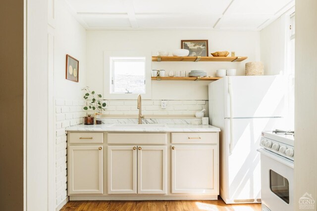 550-552 Columbia St, Hudson, NY 12534 - kitchen with white appliances, a sink, light stone counters, and open shelves