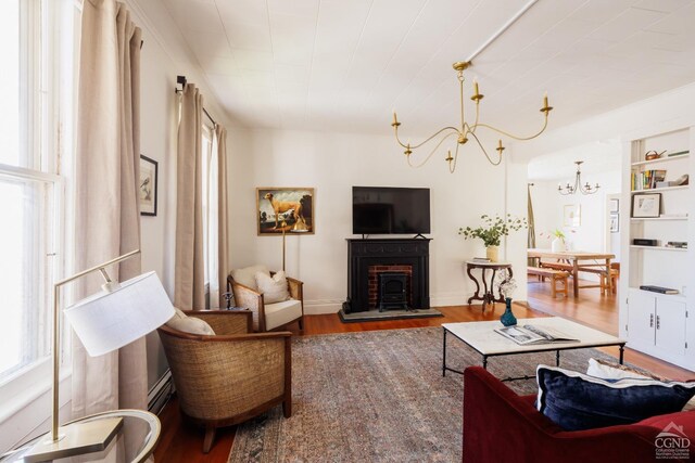 550-552 Columbia St, Hudson, NY 12534 - living area with healthy amount of natural light, wood finished floors, and a chandelier