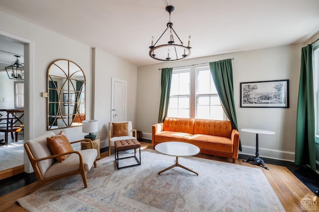 550-552 Columbia St, Hudson, NY 12534 - living area with wood finished floors, baseboards, and a chandelier