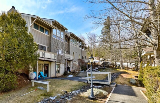 92 Highlands Ln Unit A8, Hunter, NY 12442 - back of house with a chimney