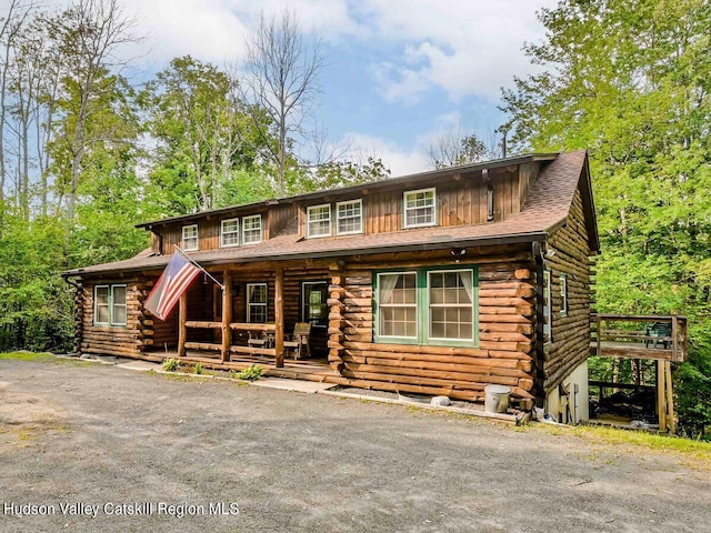 log home with covered porch