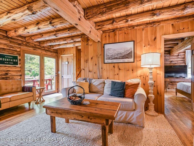 living room with beamed ceiling, light hardwood / wood-style floors, and wood ceiling