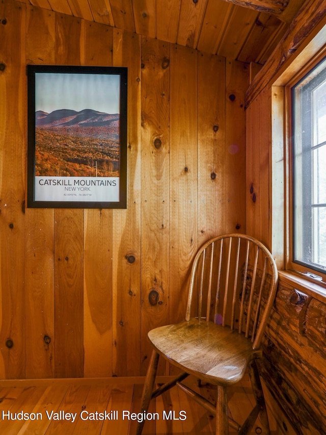 living area featuring wood walls and wood ceiling