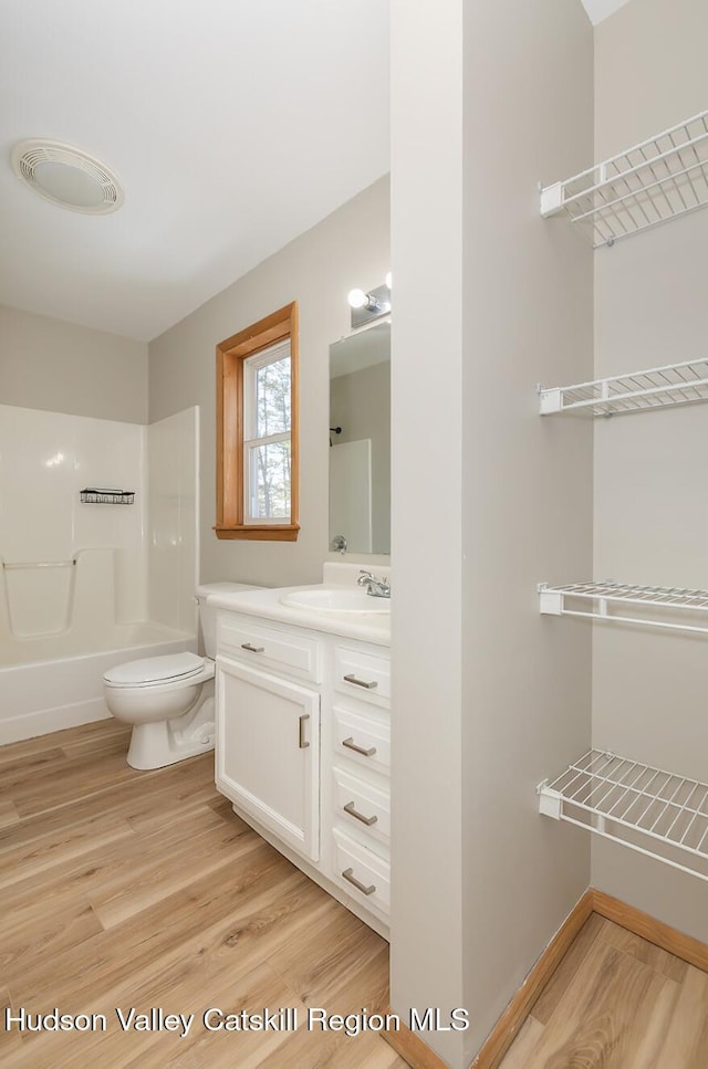 186 Meadow Brook Ln, Greenville, NY 12083 - full bath featuring wood finished floors, vanity, toilet, and bathtub / shower combination
