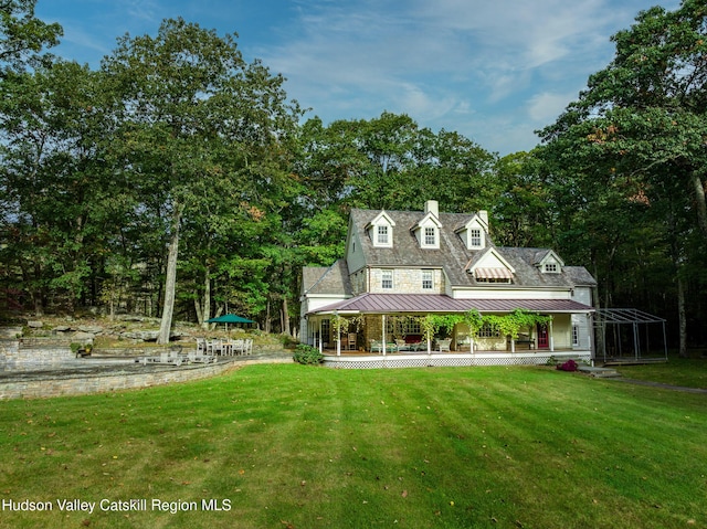465 High Point Mountain Rd, West Shokan, NY 12494 - view of front of house with a standing seam roof, a porch, a front yard, a chimney, and metal roof