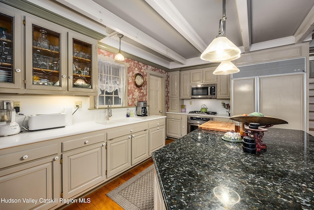 465 High Point Mountain Rd, West Shokan, NY 12494 - kitchen with appliances with stainless steel finishes, wallpapered walls, a sink, cream cabinetry, and wood finished floors