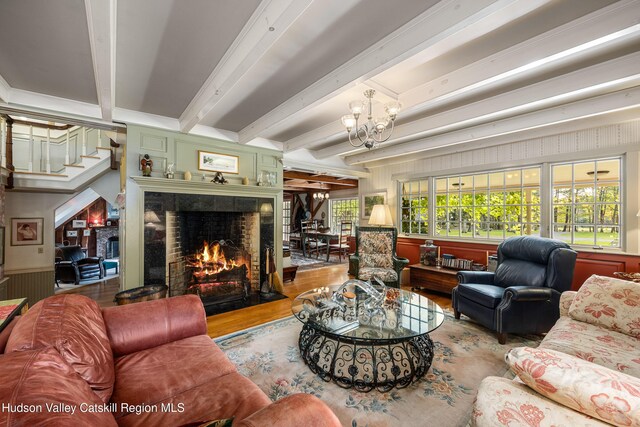 465 High Point Mountain Rd, West Shokan, NY 12494 - living area with a fireplace, wood finished floors, a chandelier, beam ceiling, and stairs