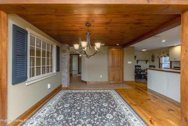 dining area featuring wooden ceiling, an inviting chandelier, and light hardwood / wood-style floors