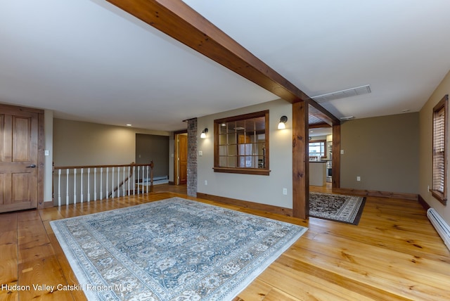 living room with a baseboard radiator and light hardwood / wood-style flooring